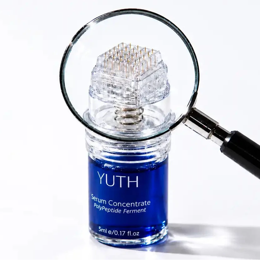 A small cylindrical bottle of YUTH copper peptide serum concentrate with a blue label and clear cap, shown on a white background with a magnifying glass hovering over it.